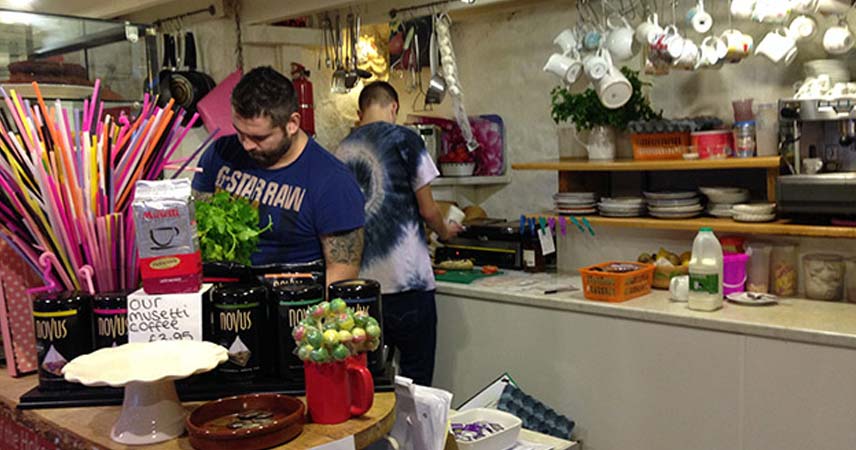 Two men preparing food in a kitchen in Cornwall