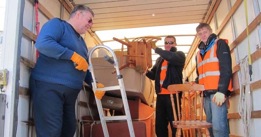 Picture of three men in a van recycling furniture as a part of RE:SOURCE at Bosinver.