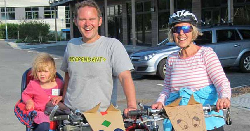 A man, child and Pat from Bosinver cycling in Cornwall.