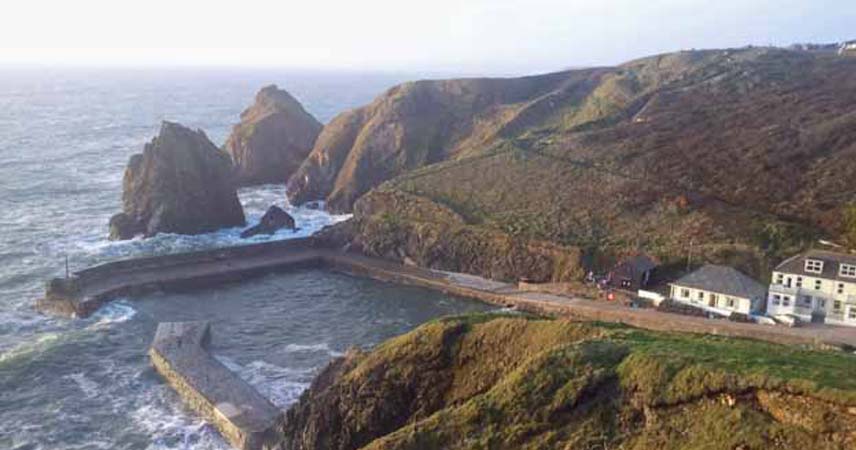 Aerial photo of the stormy sea and harbour at Mullion Cove in Cornwall