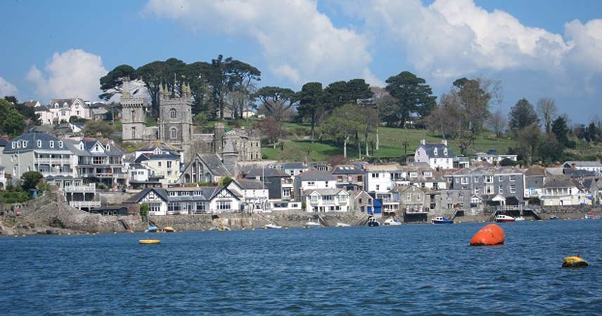 Boast in a harbour outside a coastal town in Cornwall.