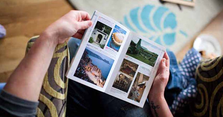 Aerial shot of a person holding a Cornish tourism guide