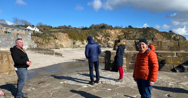 Lyndon Allen left with Pat Smith aka Action Nan, right, on a historical guided walk through Charlestown in Cornwall