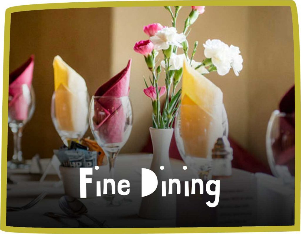 Green framed image of a table laid up for dinner. White text reads 'fine dining'