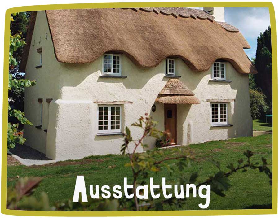 Picture of a thatched cottage with beige walls and a small garden in front of it.
