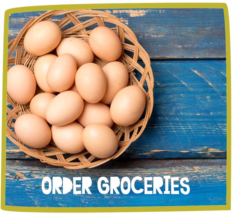 Close up of eggs in a basket on a blue table.
