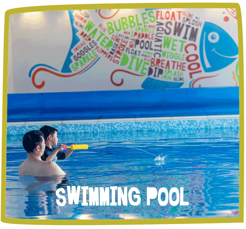Father and son playing with a water gun with a swimming pool at Bosinver.