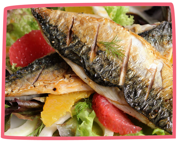 Close up of seared fish and salad on a plate.