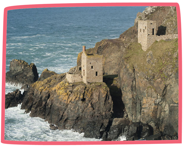 View of buildings situated across the Cornwall coast, close to the sea.