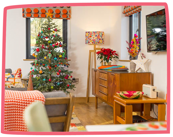 Living room in a cottage at Bosinver decorated for Christmas.