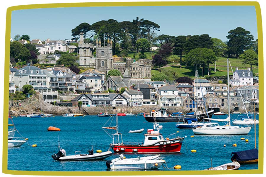 Boast in a harbour outside a coastal town in Cornwall.